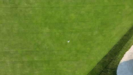Golf-course-with-flagstick-in-hole