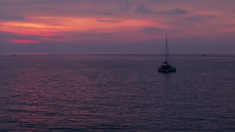 sunset over the ocean with a yacht