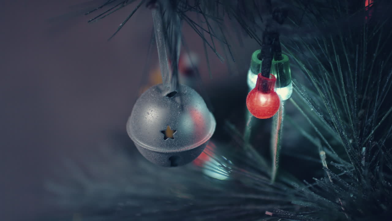 Silver Metal With Star-Shaped Cutout Christmas Ornament And Lights - Closeup, Slider Shot