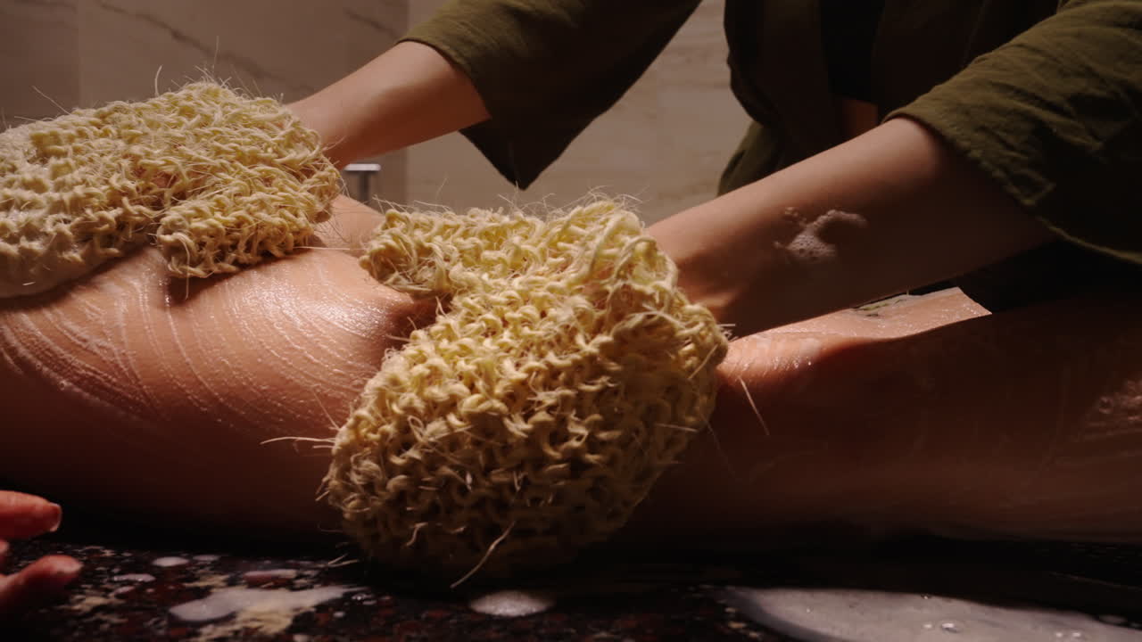 Woman receiving a body scrub at a spa