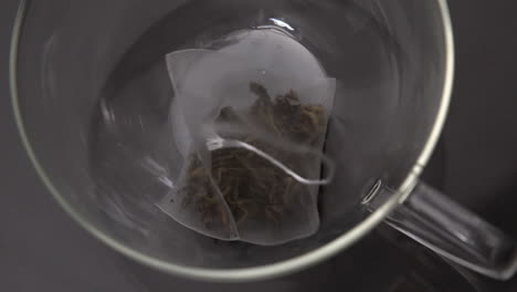 Teabag-falling-into-glass-cup