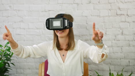 a happy young professional woman using a vr virtual reality headset in an office