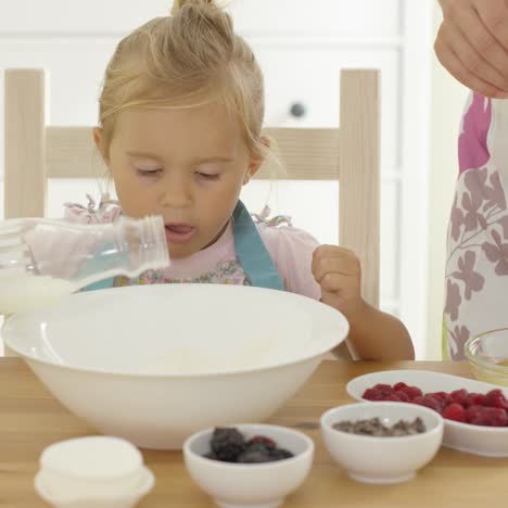 cute baby baking with woman in a kitchen