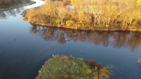 aerial view of kayaking on a river with autumnal scenery