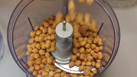 puting chickpeas in the mixer