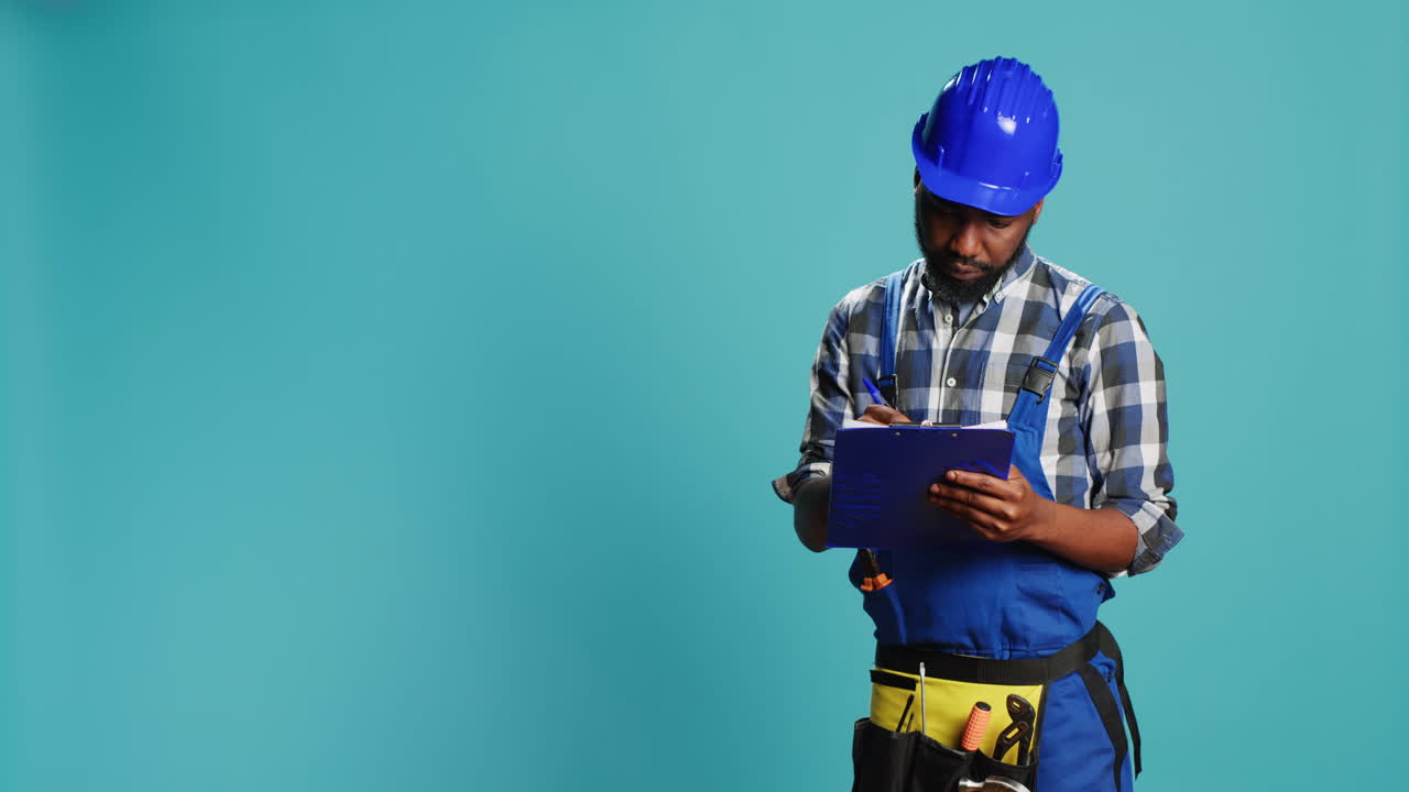 Young handyman making calculations on files