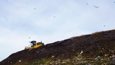 Stack-of-different-types-of-large-garbage-dump,-plastic-bags,-and-landfill-full-of-trash,-environmental-pollution,-truck-dump-waste-products-polluting-in-a-dump,-distant-medium-shot