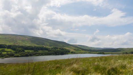 Lapso-De-Tiempo-De-Las-Nubes-Moviéndose-Sobre-Un-Lago-En-El-Campo-Inglés,-Día-Soleado