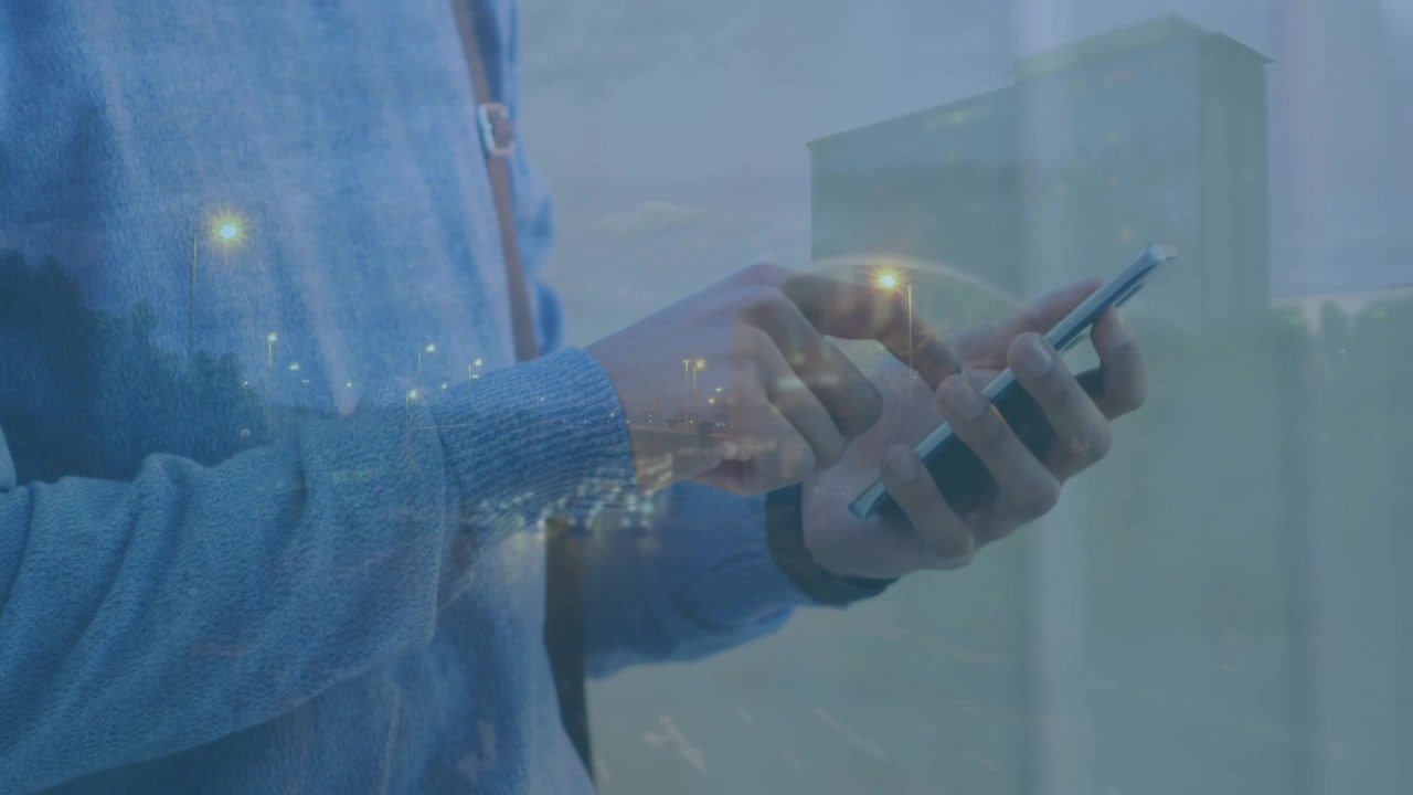 Animation of cars on street over caucasian businessman using smartphone
