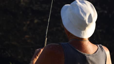 person fishing at a lake during sunset