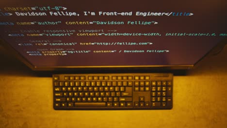 computer screen showing code and keyboard