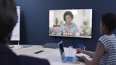 Diverse-business-people-on-video-call-with-african-american-female-colleague-on-screen