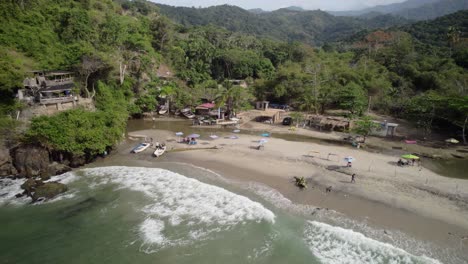 people play on sandy tropical beach, coastline green mountains and turquoise sea water splash, osma beach