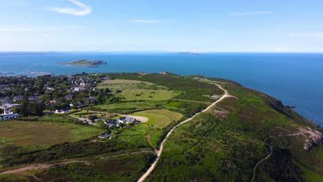 aerial orbiting shot of dramatic coastline of howth peninsula in ireland