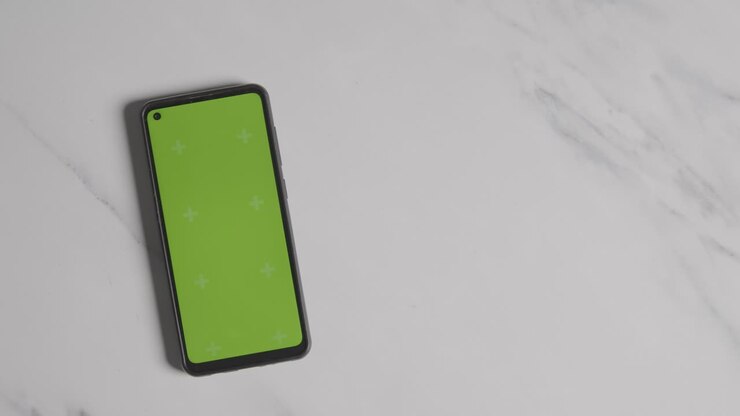 Overhead Currency Shot Of Hand Grabbing US 10 Dollar Bill Next To Green Screen Mobile Phone
