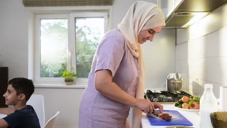 islamic woman wearing hiyab in the kitchen.