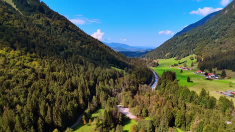 fantastic view of the picturesque mountains overgrown with pine tree woods. aerial perspective on the beautiful valley with some cottages in it.