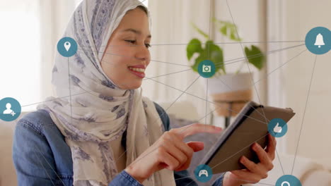 animation of connections with icons over biracial woman in hijab using tablet