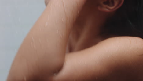 mujer atractiva tomando una ducha tocando la piel húmeda disfrutando de un spa de lujo limpiando el cutis suave