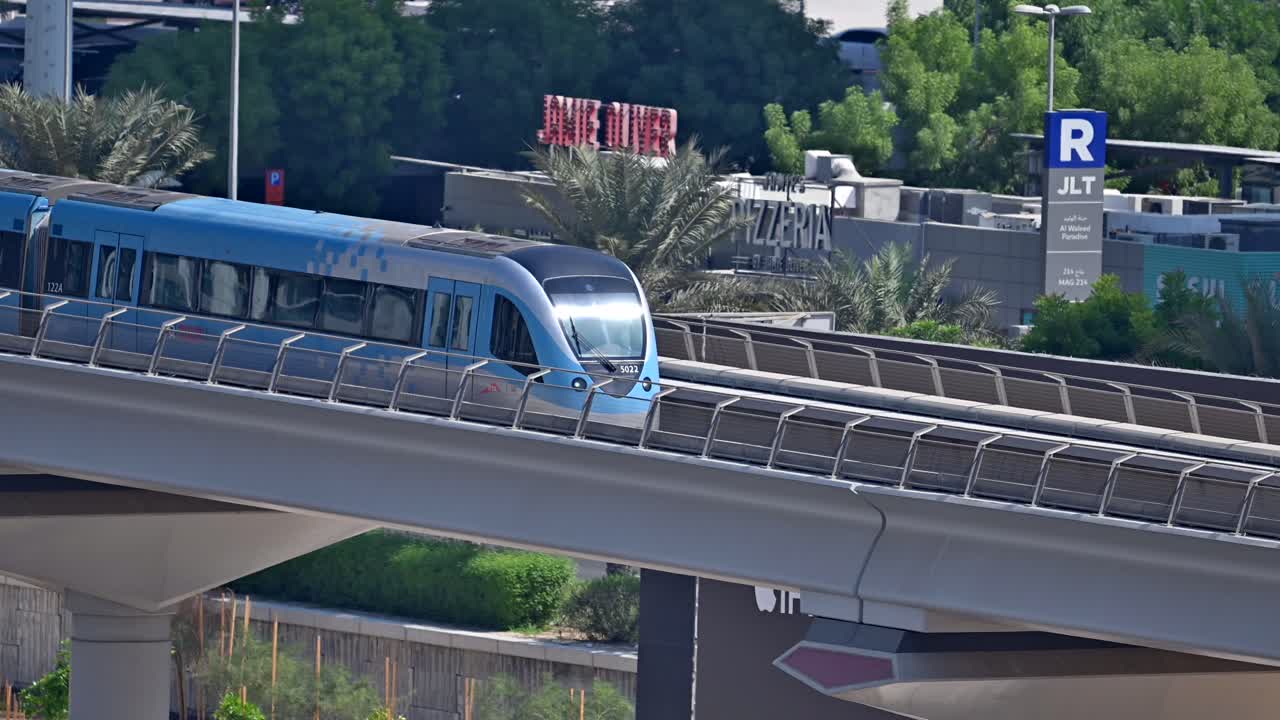 A close-up of a Dubai Metro train as it heads to its next stop along Sheikh Zayed Road in Dubai, UAE