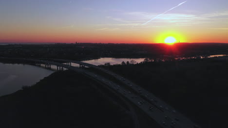 an aerial view over a parkway during sunset with a drone camera