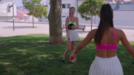 Two women playing paddle ball in the park