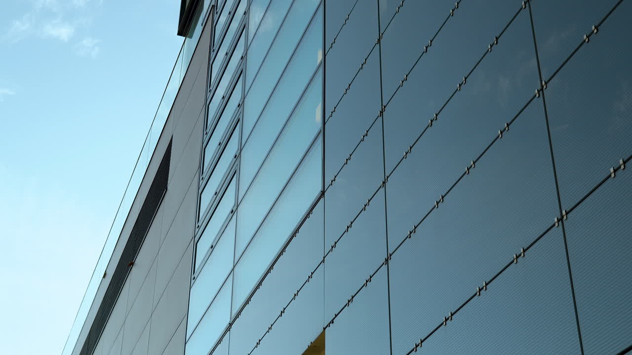 Close-up of modern building's glass facade with steel cables