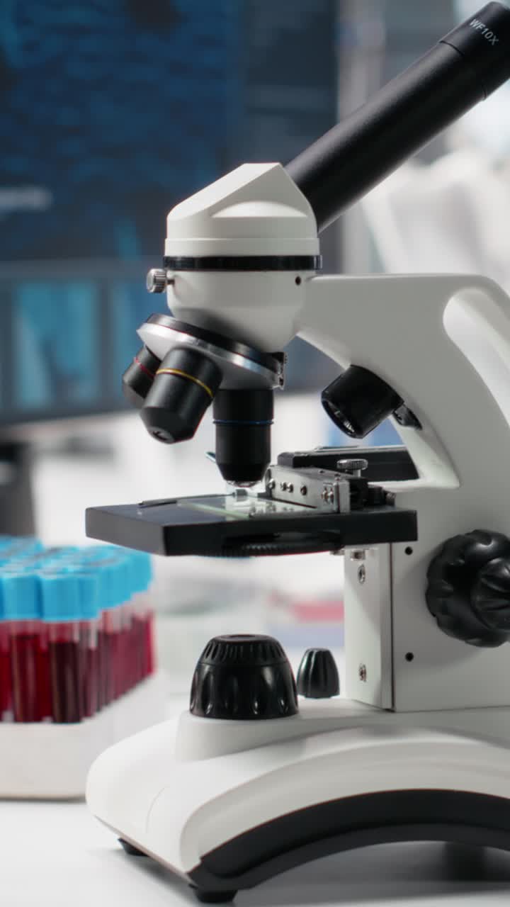 Vertical video Computer in biotechnology laboratory showing molecular model and microscope