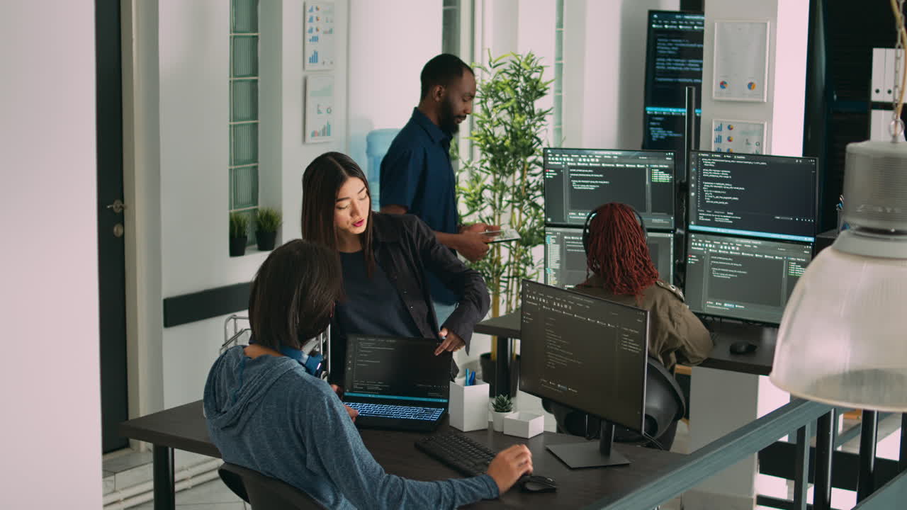 Asian team of artificial intelligence cloud programers talking about programming