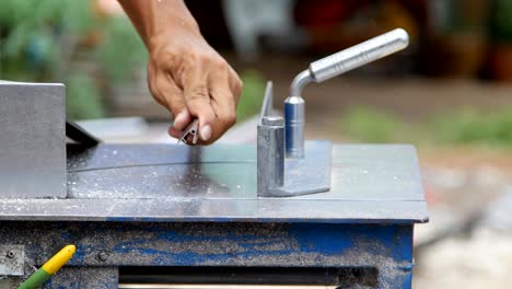 professional worker cutting aluminium with grinder blade