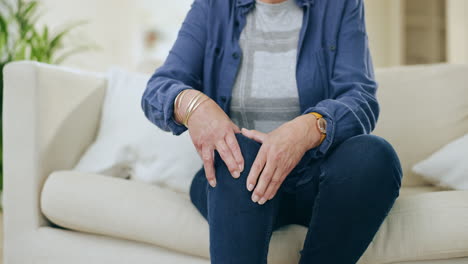 knee pain, hands and senior woman on a sofa