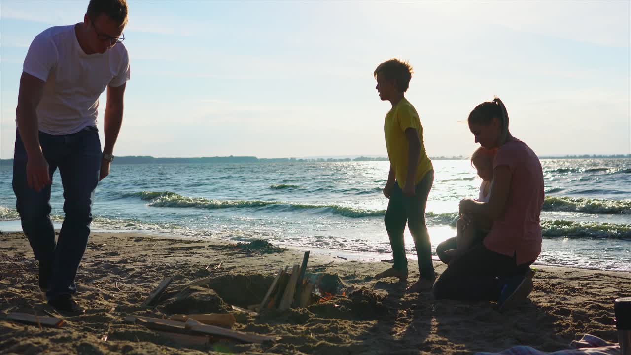 Family enjoying a campfire on the beach