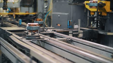 metal detail with copper wire on conveyor. production electrical appliances