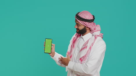 middle eastern guy shows greenscreen