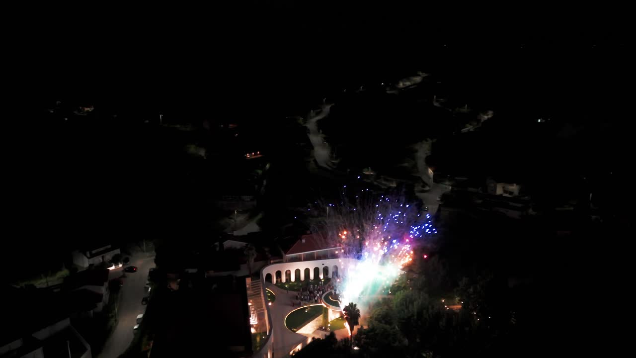 Aerial - vibrant fireworks and dazzling lights illuminate the night sky in a stunning display