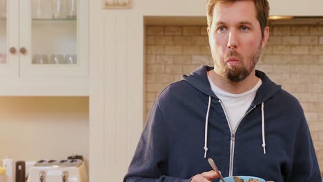 Young-man-having-breakfast-in-the-kitchen-4K-4k