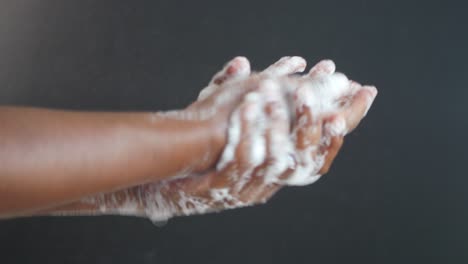 woman washing her hands with soap