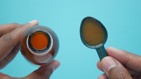 liquid medication in measuring spoon