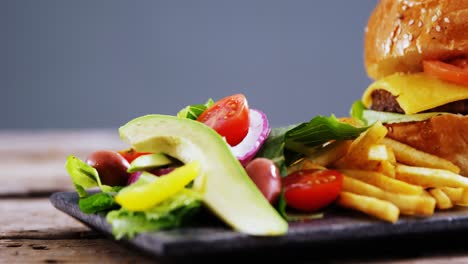 snacks and salad on slate board