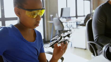 girl looking at drone at desk 4k