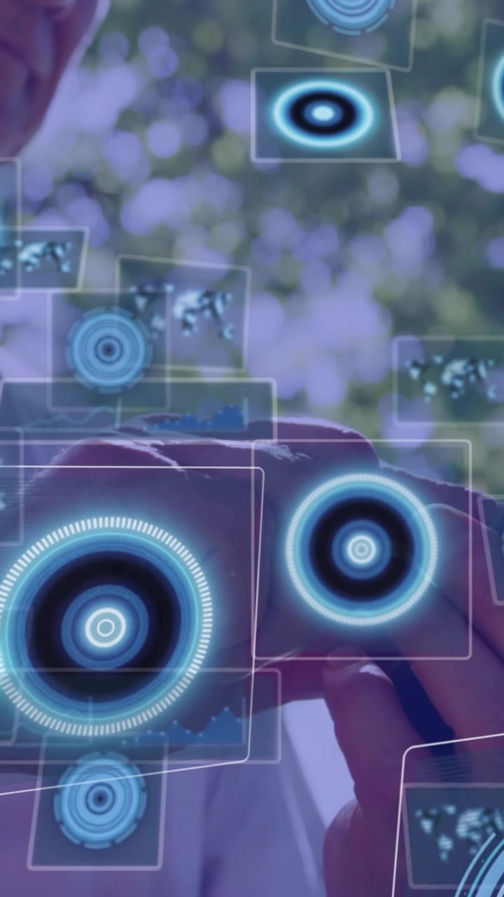 Animation of digital screens with data over caucasian man using smartphone