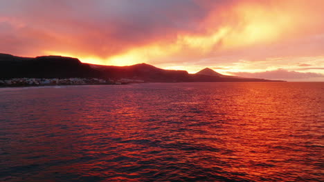 colourful sunset over the ocean on gran canaria island, drone shot