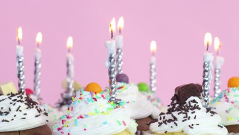 birthday party cup cakes with cream and burning candles