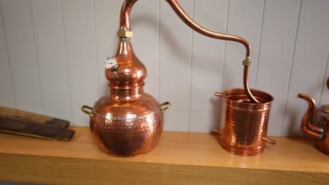 copper containers displayed on a wooden shelf