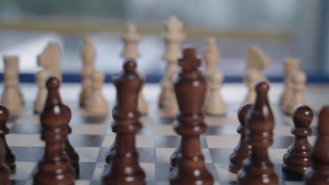 Racking-Focus-from-White-Chess-Pieces-to-Wooden-Black-Army-in-Foreground