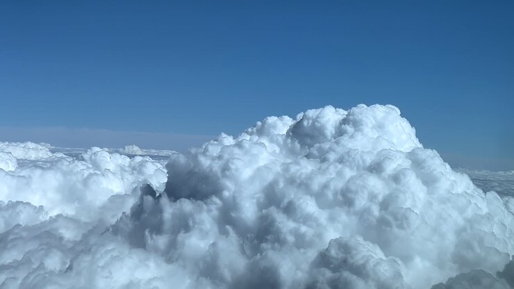 POV flying near a massive cumulonimbus stormy clouds