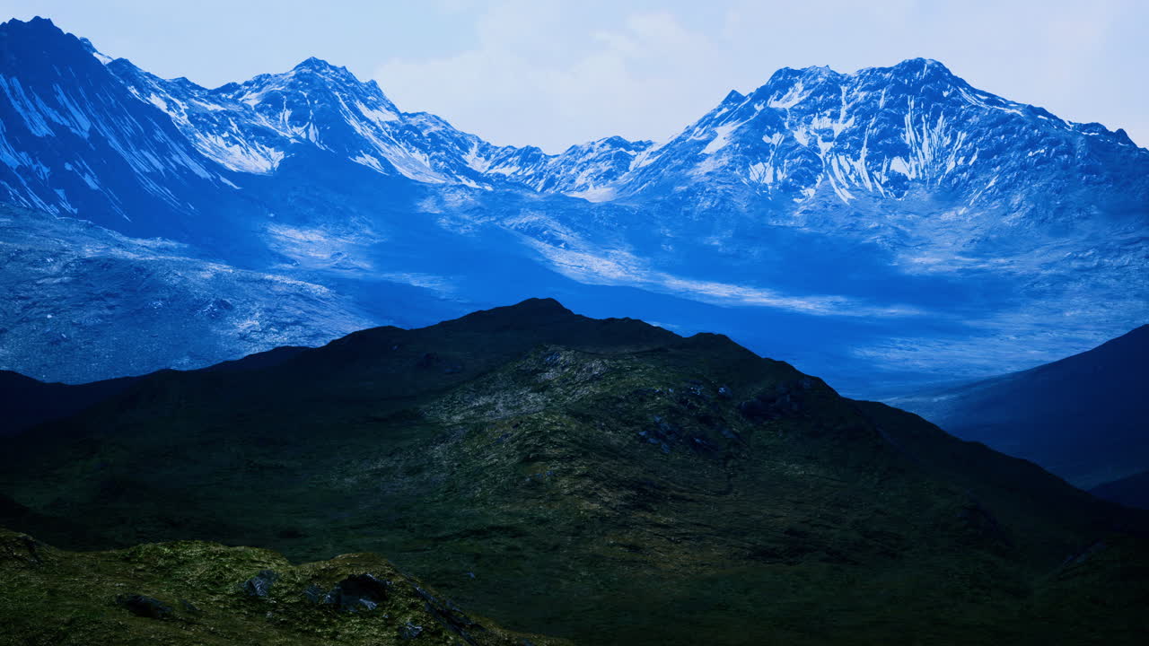 Majestic blue mountain landscape with snow capped peaks and lush valleys