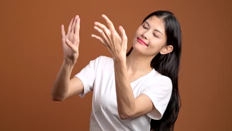 thai traditional dance isolated. thai woman in white t-shirt performing thai dance in front of camera.