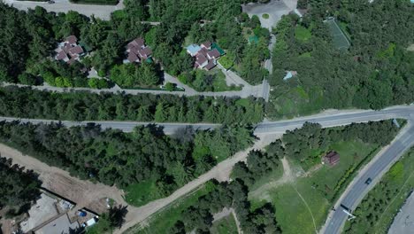 drone-shoot-around-tbilisi-city-at-the-nature-side-of-city-for-a-car-passing-by-on-the-road-with-a-lot-of-green-trees-on-the-side-of-the-drone