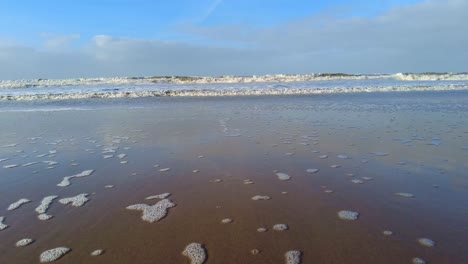 sea waves along katwijk aan zee beach coastline in south holland